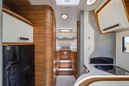 an interior view of an rv with a kitchen and stairs at Autocaravana Baron 573 in Cerdanyola del Valles