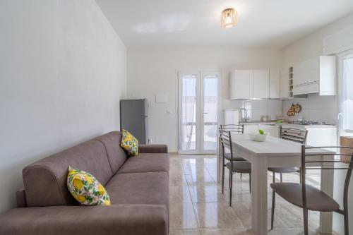 a living room and kitchen with a couch and a table at Littiricci in Marzamemi