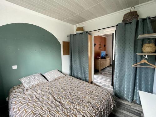 une chambre avec un lit dans une pièce aux murs bleus dans l'établissement Appartement Royat bourg, à Royat