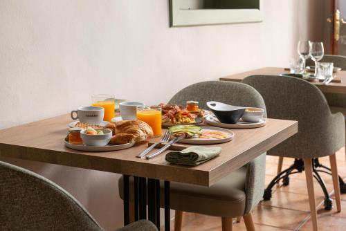 a breakfast table with breakfast foods and orange juice at Can Xim-Turismo de Interior in Alaró