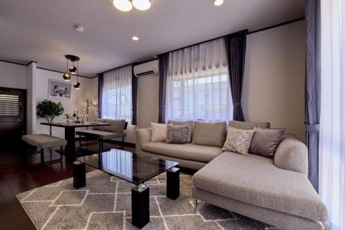a living room with a couch and a table at RISA INN Fuji in Fujiyoshida