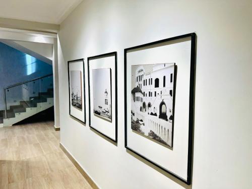 a group of framed photographs on a wall at The Onyx Villa, Accra in Accra