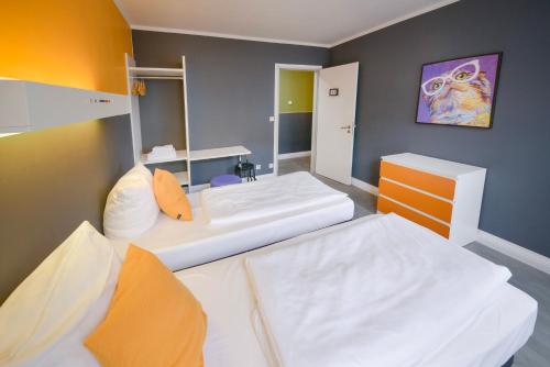 a room with two beds in a room at Old Town Hostel in Berlin