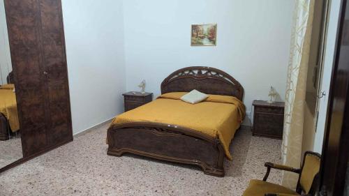 a bedroom with a bed and two night stands at Vititta Appartamenti in Trapani