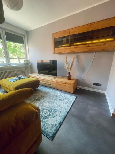a living room with a flat screen tv and a couch at Ferienwohnung Hafennest 15206 in Leer