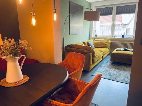 a living room with a table and a couch at Ferienwohnung Hafennest 15206 in Leer