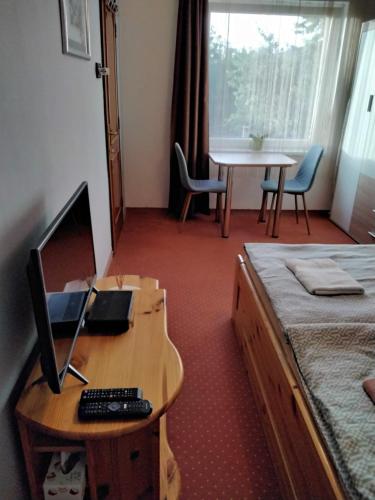 a hotel room with a desk with a computer on it at Magdaléna Vendégház in Esztergom