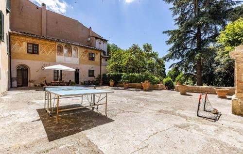 a ping pong table in front of a building at Villa Martelli in Capannoli