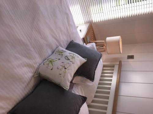 a bedroom with two beds with pillows and a staircase at Ebba Lodge in Eyemouth