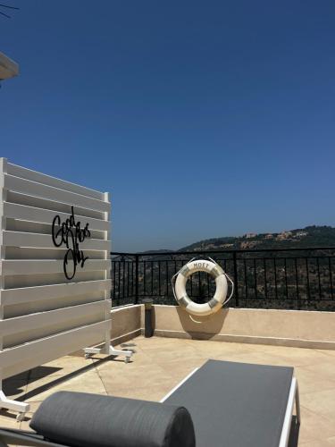 a balcony with a bench and a hammock at Beit Lebbos Boutique Hotel in Beït ed Dîne