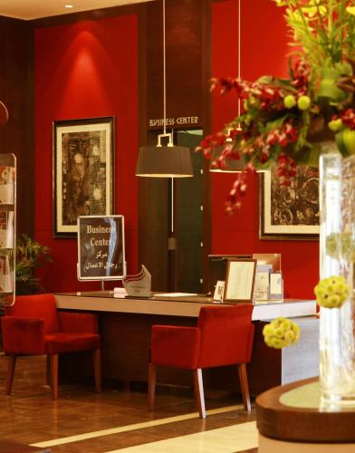 a desk in a store with red walls and red chairs at Crowne Plaza Amman by IHG in Amman