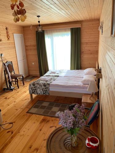 a bedroom with a bed in a wooden room at HOMELAND in Mestia