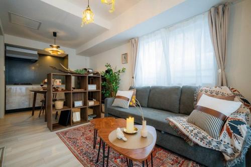 a living room with a couch and a table at Journey-Tanukikouji-MD303 in Sapporo