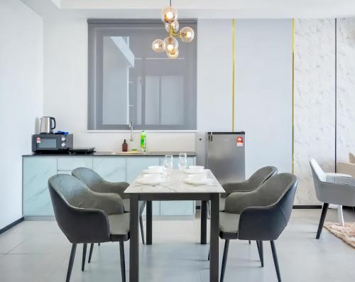 a dining room with a table and chairs at Urban Suites George Town in Jelutong