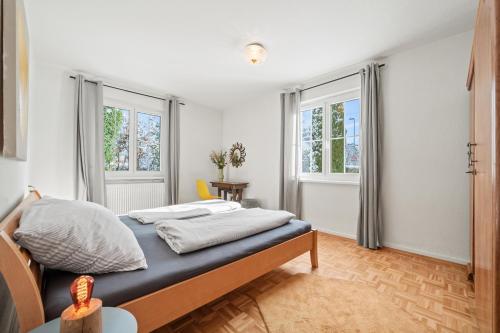 Кровать или кровати в номере Apartment SEEwiese mit großem Garten und autemberaubenden Alpenpanorama