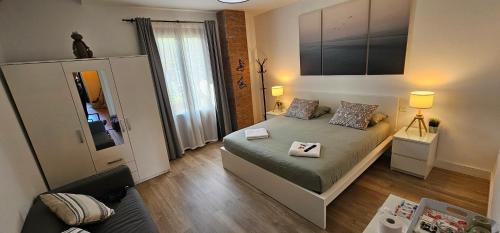 a small bedroom with a bed and a mirror at Hotel Tuul Etxea in Galdakao