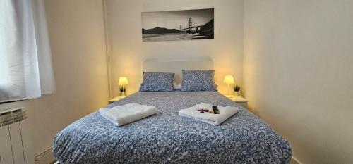 a bedroom with a bed with two pillows on it at Hotel Tuul Etxea in Galdakao