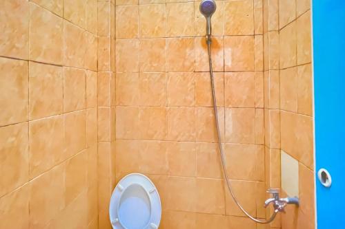 a bathroom with a shower and a toilet at Amira House Kisaran RedPartner in Kisaran