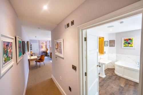 a bathroom with a tub and a sink and a toilet at The Assembly House in central Norwich in Norwich