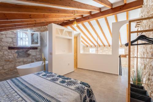 a bedroom with a bed and a tub in a room at Las Casitas Del Mar in Alicante