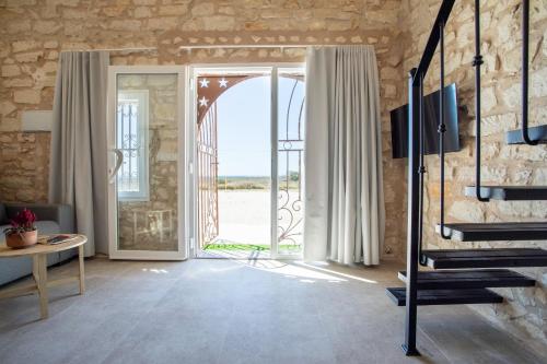 a living room with a door leading to a patio at Las Casitas Del Mar in Alicante
