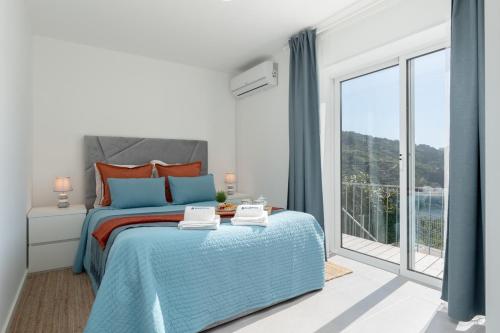 a bedroom with a bed and a large window at Host Wise - Solar de Pisões in Marco de Canavezes