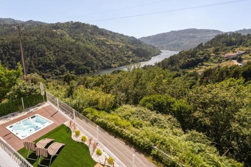 an aerial view of a house with a swimming pool and a river at Host Wise - Solar de Pisões in Marco de Canaveses