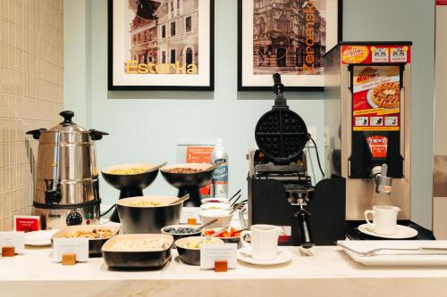 a kitchen counter with food on a counter top at Hilton Garden Inn Radom in Radom