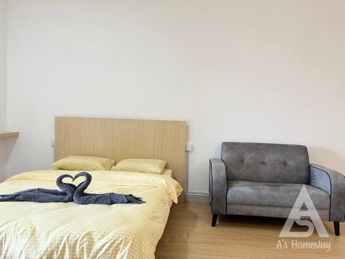 two swans on a bed in a bedroom with a chair at Netizen Soho 2pax MRT Cheras Wi-Fi VsHome in Cheras