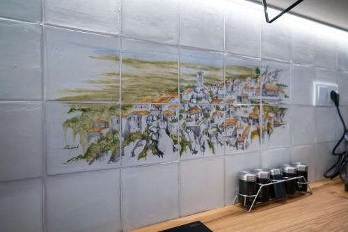 a mural on a wall in a room at Refúgio da Quinta Nere Maitia in Santarém