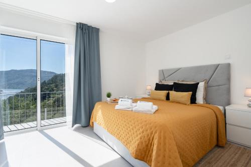 a bedroom with a bed and a large window at Host Wise - Solar de Pisões in Marco de Canaveses