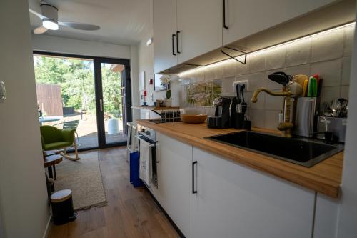 a kitchen with a sink and a counter at Refúgio da Quinta Nere Maitia in Santarém