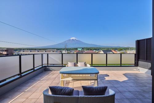 a patio with a table and chairs on a roof at Miire Mt Fuji Natural in Fujikawaguchiko
