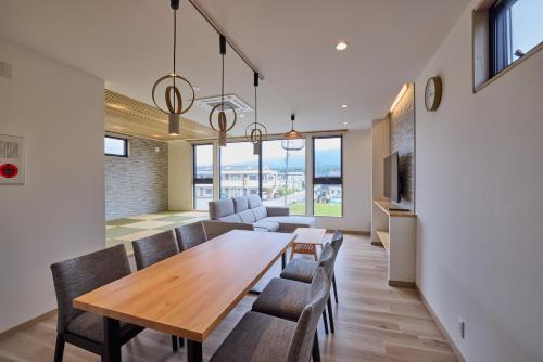 a dining room and living room with a table and chairs at Miire Mt Fuji Natural in Fujikawaguchiko
