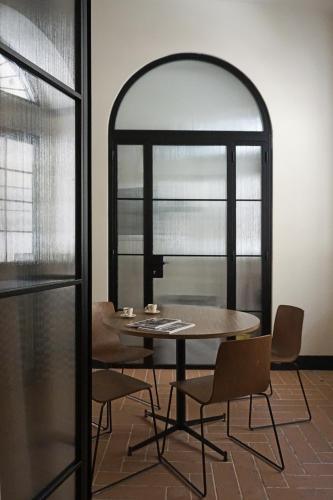 a table and chairs in a room with a window at La Corte Dei Panni in Rome