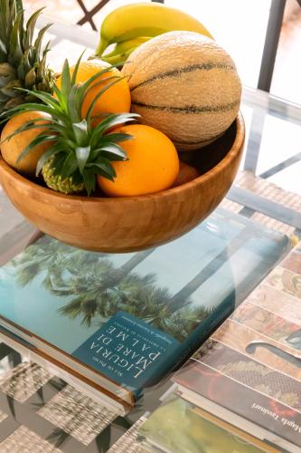 a bowl of fruit sitting on top of a glass table at Chiwi's Home in Vado Ligure