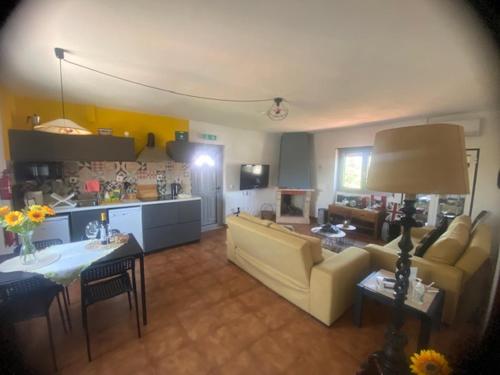 a living room with a couch and a table at Casa Almenara in Quinta do Anjo