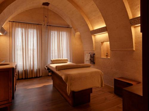 a bedroom with a bed and a large window at Argos in Cappadocia in Uchisar