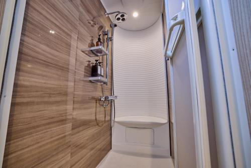 a bathroom with a toilet and a glass shower at Miire Mt Fuji Traditional in Fujikawaguchiko