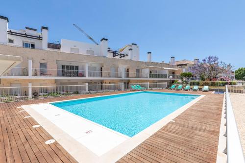 a swimming pool in front of a building at Apartment Andorinha-pretty Holiday Home With Pool in Santa Luzia
