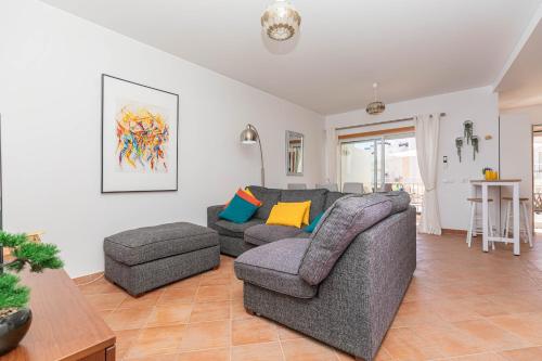 a living room with a couch and a chair at Apartment Andorinha-pretty Holiday Home With Pool in Santa Luzia