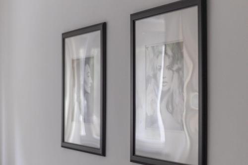 two framed pictures of a woman on a wall at Arena 35 in Milan