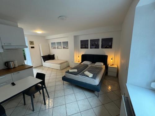 a bedroom with a bed and a desk in a room at Cozy flat near Tivoli park with free parking in Ljubljana