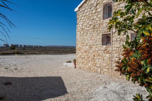 a stone building with a window on the side of it at Las Casitas Del Mar in Alicante