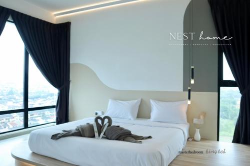 a hotel room with a bed with a towel on it at Midvalley Southkey Mosaic Suite by Nest Home in Johor Bahru