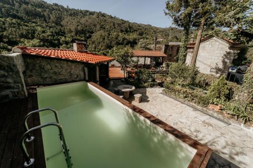 a swimming pool in the backyard of a house at HAGAH Alojamentos - Gerês in Vieira do Minho