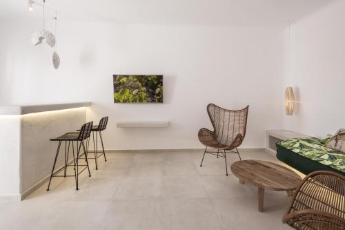 a living room with chairs and a couch at Art Hotel Santorini in Pirgos