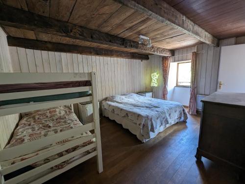 a bedroom with two bunk beds in a room at Le lys de la vallée in  Labastide-sur-Bésorgues