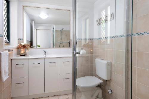 a bathroom with a toilet and a sink and a shower at Pets Paradise - Top location with FREE parking in Gold Coast