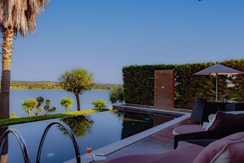 a swimming pool with a view of the water at Montargil Monte Novo in Montargil